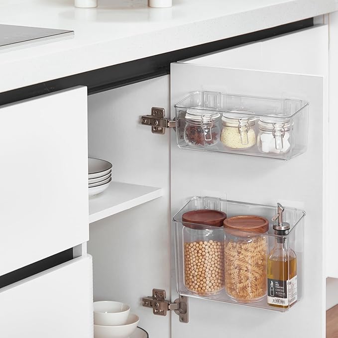 Kitchen cabinet with clear storage bins holding jars of food