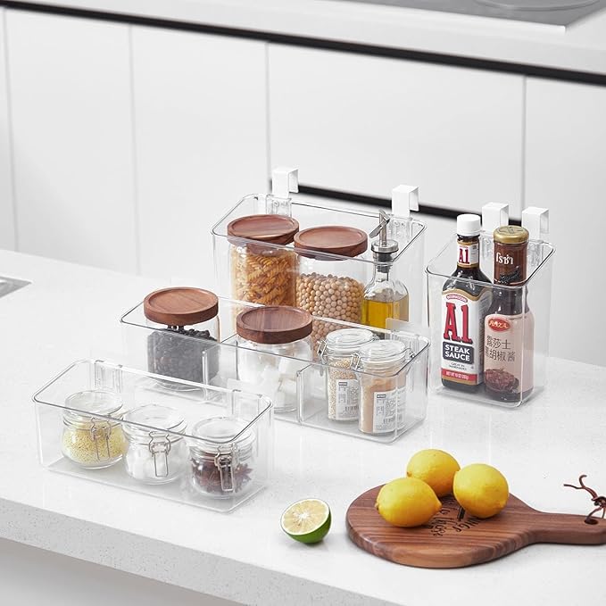 Clear kitchen storage containers with food items on a countertop